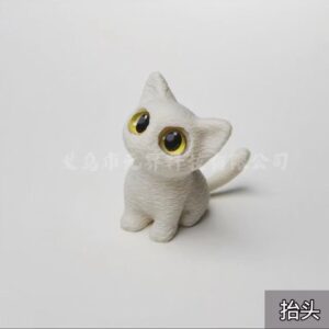 White cat - crouching down and looking up