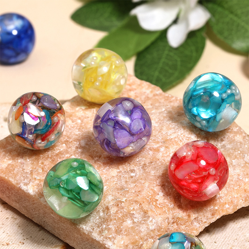 Wholesale Irregularly shaped, vibrant mother-of-pearl inlaid with translucent, perforated beads.