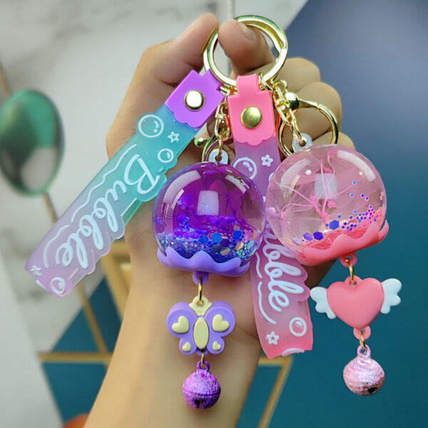 Wholesale Cross-border cartoon oil dried flower quicksand ball keychain wind bell flower pendant acrylic jewelry quicksand bottle