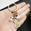 Wholesale Cross-border Hot Cartoon Oil Dropping Pearl Tea Cup White Cat Keychain Metal Alloy Bag Jewelry Pendant