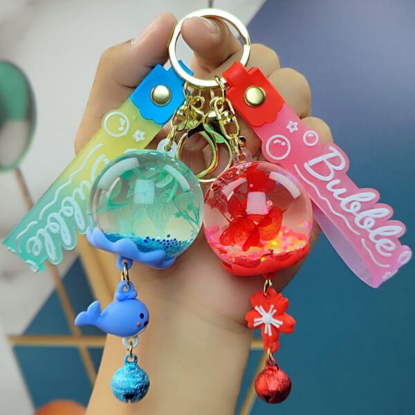 Wholesale Cross-border cartoon oil dried flower quicksand ball keychain wind bell flower pendant acrylic jewelry quicksand bottle
