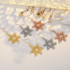 Wholesale Large gold-tone earrings with micro-embellished snowflakes