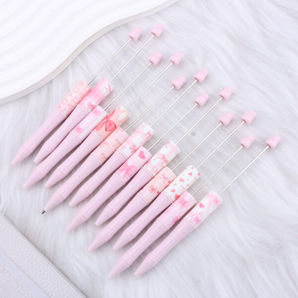 Wholesale New DIY pink bow-print beaded pen, perfect for a girly look.