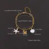 Wholesale Classic Summer Ocean Style Gold Stainless Steel Initial Bracelet Shell Starfish Pin Chain Ladies Bracelet Elegant Simple Design
