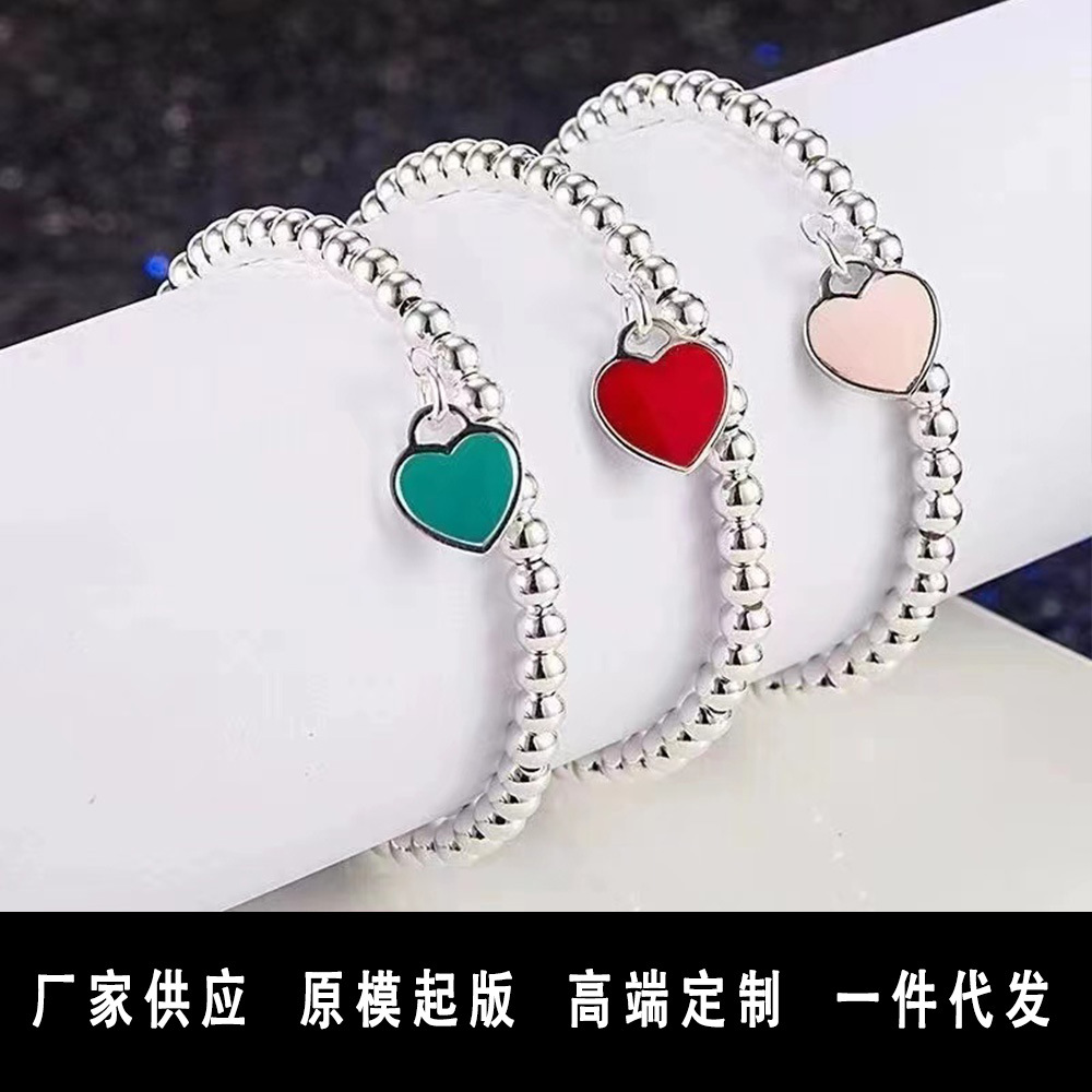Wholesale brass-plated sier heart bracelet with enamel blue, red, and pink hearts. High-value women's bracelet, opshipping available.