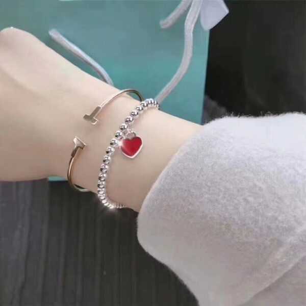 Wholesale brass-plated sier heart bracelet with enamel blue, red, and pink hearts. High-value women's bracelet, opshipping available.