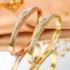 Wholesale Geometric Bangle For Women In Golden Titanium Steel With Electroplated Finish And Rhinestone Inlay