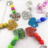 oly-de77f684525ce47a32f9c098b30e7673 Wholesale Magic Acrylic Love Silicone Beaded Keychain Bag Key Pendant