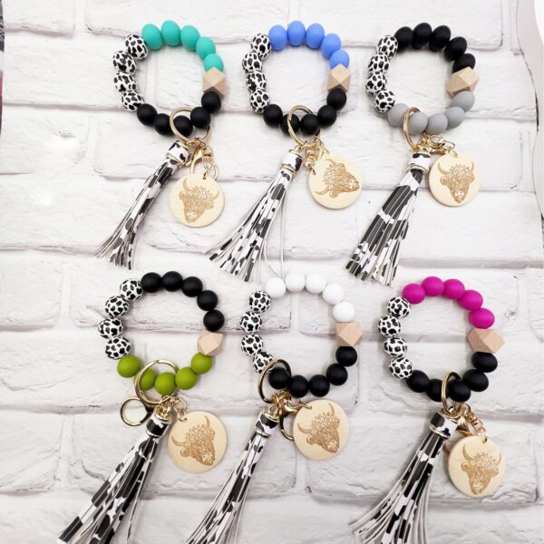 oly-de937d26b70906e89fd3f7b4c40a8fd1 Wholesale Western Style Dairy Wood Beads Silicone Beaded Round Wood Pieces Yak Keychain
