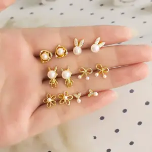 Wholesale 1 Pair Modern Style Simple Style Rabbit Flower Bow Knot Plating Inlay Copper Pearl Zircon 18k Gold Plated Ear Studs