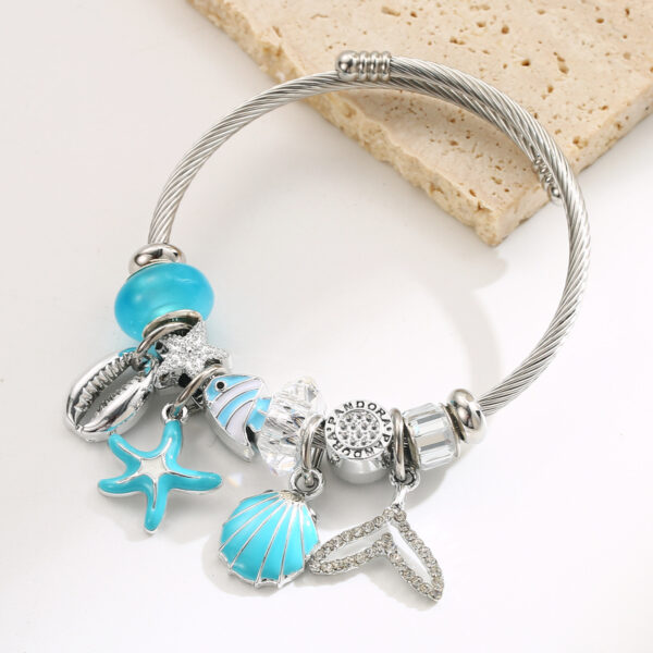 Wholesale Stainless steel bracelet with starfish, seashell, bear pendant, and heart-shaped charm for women.