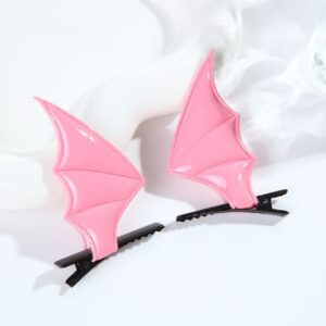 A pair of pink devil wings hair clips