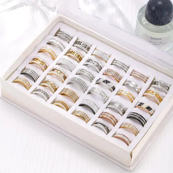 Wholesale Unisex Geometric Rings In Titanium Steel With PVD Coated Gold Plating And Rhinestone Inlay Featuring Cutting Craft