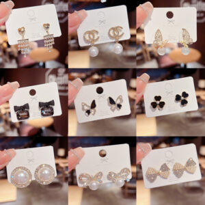 oly-0a5aa6d352dfd33a6a1719849e41e099 Wholesale Copper and silver needle Chanel-style stud earrings with diamonds, pearls, and zircon stones