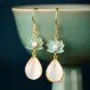 Wholesale Lotus Earrings For Women In Golden Plated Copper Featuring Freshwater Pearl Inlay