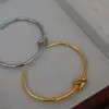 Wholesale 18K Gold Plated 304 Stainless Steel Solid Color Knot Bangle