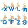 Wholesale blue crystal epoxy letter key chain pendant resin sequined butterfly key chain batch