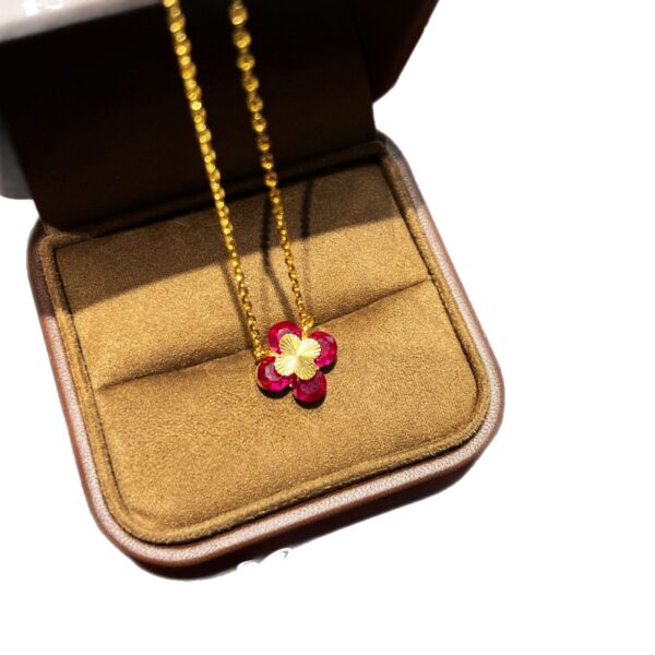 Wholesale Copper zircon four-leaf clover necklace, bracelet, and earrings set with red corundum, aquamarine, and white diamonds.