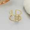 Wholesale Unisex U Shape Open Ring In Copper With 14K Real Gold Electroplated Finish Featuring May Birthstone Emerald
