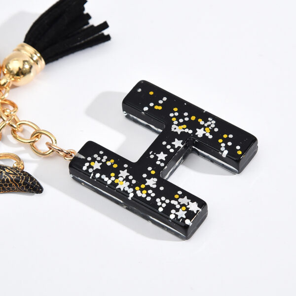 Wholesale resin black English letter car key chain pendant butterfly pendant tassel key chain decoration