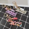 Wholesale Resin flash years digital creative accessories popular love hanging sequins mixed color keychain