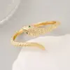 Wholesale Snake Pattern Bangle In Copper With 14K Real Gold Electroplated Finish Featuring Zircon Inlay In Gold