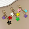 oly-531dd1048fb32b001339457dee2702aa Wholesale double-sided drip oil color flower alloy keychain creative Airpods bag pendant
