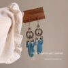 oly-54dfbba24cce91656f07134e61439baf Wholesale Ethnic Style Retro Feather Earrings Long Multi-Color Holiday Feather Earrings Beaded Design Circle Earrings