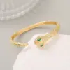 Wholesale Snake Pattern Bangle In Copper With 14K Real Gold Electroplated Finish Featuring Zircon Inlay In Gold