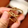 Wholesale C Shape Earrings For Women Featuring Bezel Setting Zircon Inlay Made Of Brass With 18K Real Gold Plated Finish