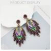 oly-73ed799364bbd6234a292ede96583b1e Wholesale Ethnic Style Carnival Festival Earrings Autumn and Winter High-end Fashion Handmade Rice Beads Feather Exaggerated Earrings for Women
