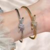 oly-8e0ad9285064530b10ca2302b3c47439 Wholesale Electroplated Copper and Plastic Snap-Clasp Bracelet — Full-Pavé, Rope-Knot Design, Non-Fading Jewelry