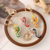 oly-9f6bd8cd6c645bfe96736c6b5ff16af7 Wholesale Creative Color Diamond-encrusted Zodiac Snake Car Keychain Zodiac Animal Bag Pendant Small Gift