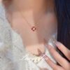 Wholesale Copper zircon four-leaf clover necklace, bracelet, and earrings set with red corundum, aquamarine, and white diamonds.