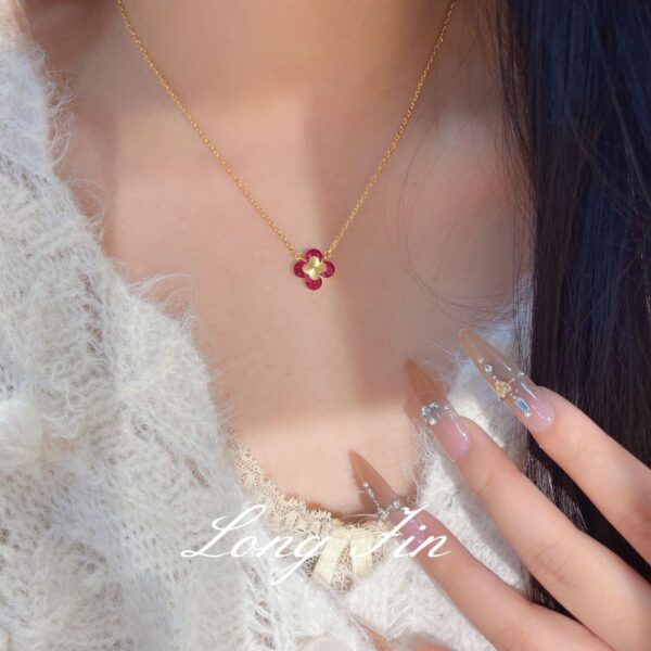 Wholesale Copper zircon four-leaf clover necklace, bracelet, and earrings set with red corundum, aquamarine, and white diamonds.