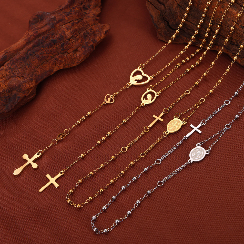 Wholesale British Style Retro Niche Personality Jewelry Embossed Figure Round Brand Tassel Cross Pendant Titanium Steel Gold Plated Necklace