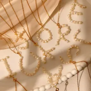 Wholesale 18K Gold Plated Titanium Steel Vacuum Electroplated Three-Dimensional Letter Pearl Trendy Necklace Handmade Unisex