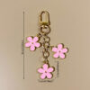 oly-a6deb75dae0c103169541f9f6574be7e Wholesale double-sided drip oil color flower alloy keychain creative Airpods bag pendant