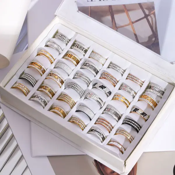 Wholesale Unisex Geometric Rings In Titanium Steel With PVD Coated Gold Plating And Rhinestone Inlay Featuring Cutting Craft