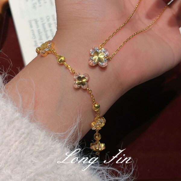 Wholesale Copper zircon four-leaf clover necklace, bracelet, and earrings set with red corundum, aquamarine, and white diamonds.
