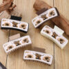 oly-acd8694d0d4dd46e19f409978b462854 Wholesale Fashionable leather PU yak Chrysanthemum White leather square hairpin simple all-match shark grip high Skull top