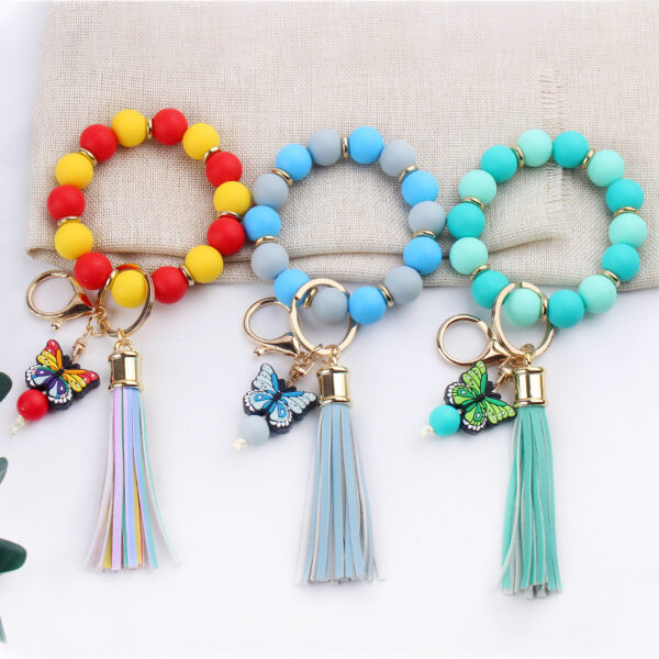 oly-c81555cd8300e89f53debc3c6c12b866 Wholesale Creative DIY Beaded Cartoon Butterfly Wrist Keychain Pendant Rainbow Leather PU Tassel Ring Key Ring Accessories
