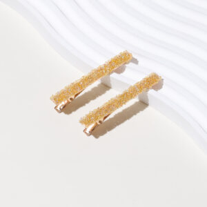 A pair of yellow diamond and gold bottom hairpins