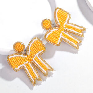 A pair of orange bow rice bead earrings