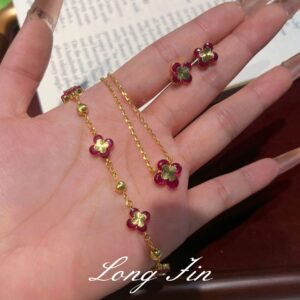 Wholesale Copper zircon four-leaf clover necklace, bracelet, and earrings set with red corundum, aquamarine, and white diamonds.