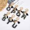 Wholesale resin black English letter car key chain pendant butterfly pendant tassel key chain decoration