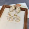 Wholesale French Style Oil Painting Drip Earrings Beige Sweet Niche Design Versatile Elegant Shell Embedded Copper Earrings For Women