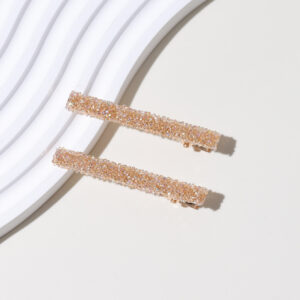 A pair of champagne gold bottom hairpins