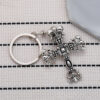oly-eb891f67474a46e23e92a412bbf0ba2d Wholesale Crow flame cross keychain niche punk retro do pendant car pendant
