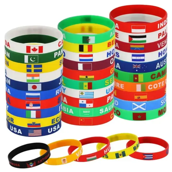 oly-f460bc2685524aec1ddabf3ecbc20c5a Wholesale Multicolor Nordic Style Asymmetrical National Flag Wristband In Silica Gel With Nylon Chain Material For Couples